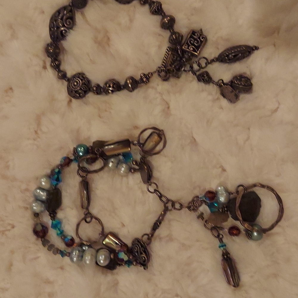 2 Tres Jolie bracelets- fun and dangly on wrists.